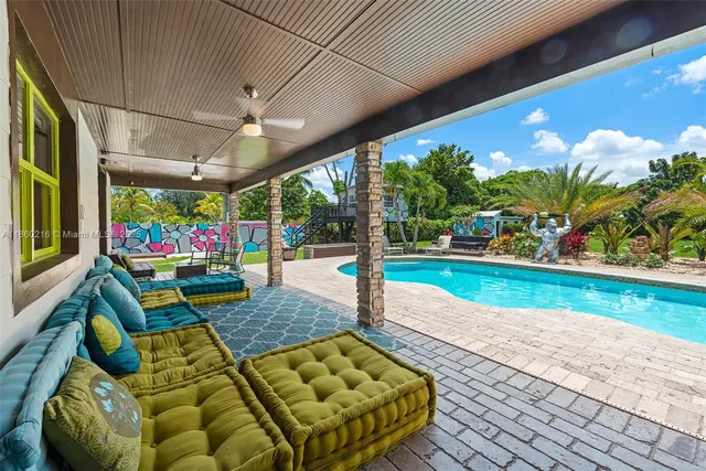 a view of a swimming pool with sitting area