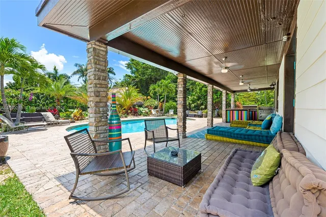 a view of a swimming pool with an outdoor seating