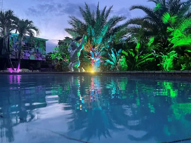 a backyard of a house with lots of green space and lake view