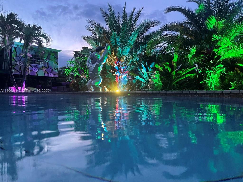 250 Northeast 158th Street Miami, FL 33162 - Photo 5 of 80 a backyard of a house with lots of green space and lake view