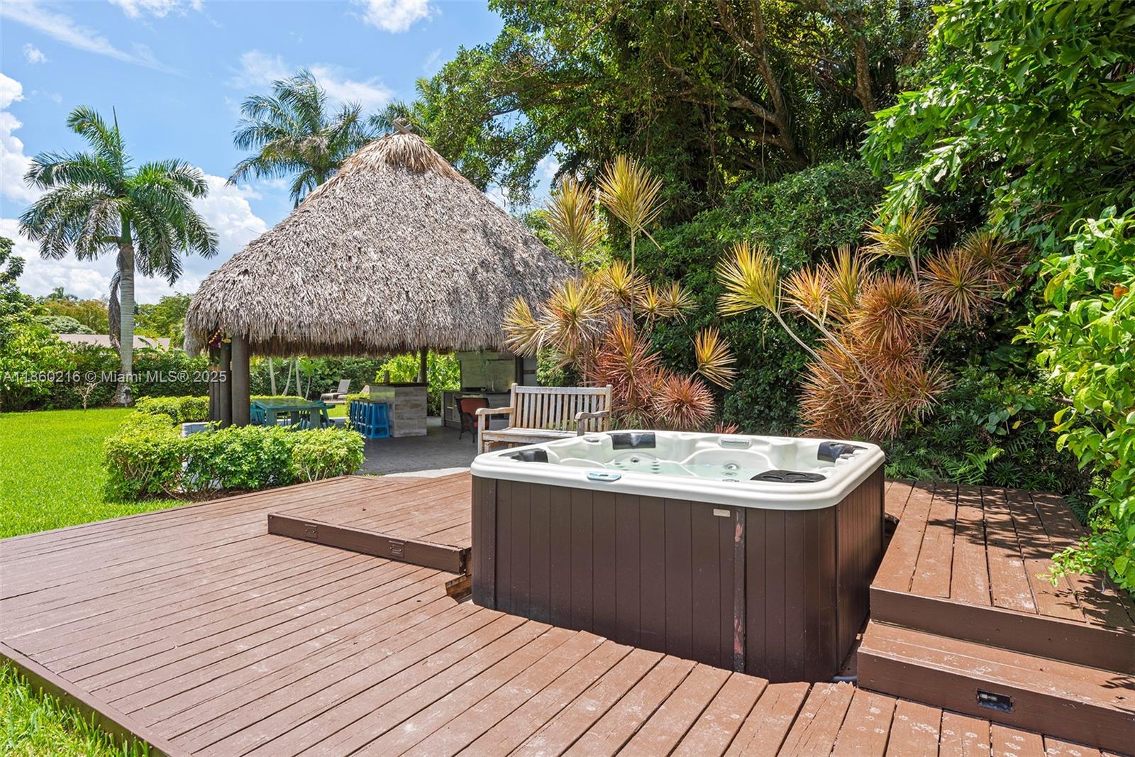250 Northeast 158th Street Miami, FL 33162 - Photo 56 of 80 a view of a wooden deck besides a house with a yard