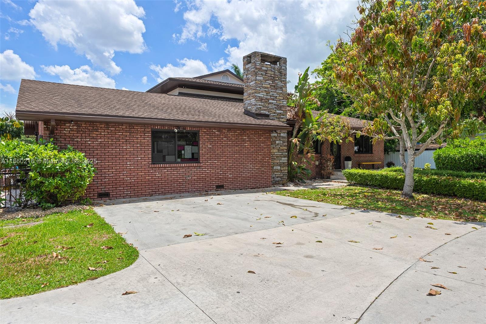 250 Northeast 158th Street Miami, FL 33162 - Photo 64 of 80 a front view of a house with a yard