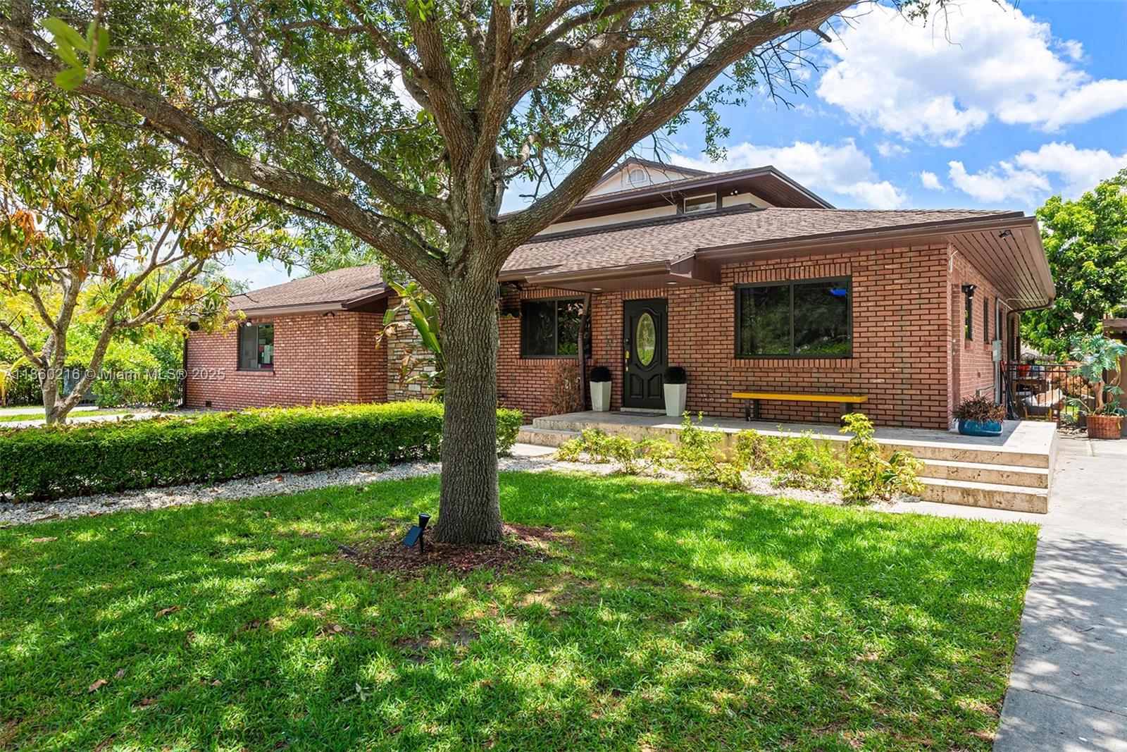 250 Northeast 158th Street Miami, FL 33162 - Photo 66 of 80 a front view of house with yard and green space