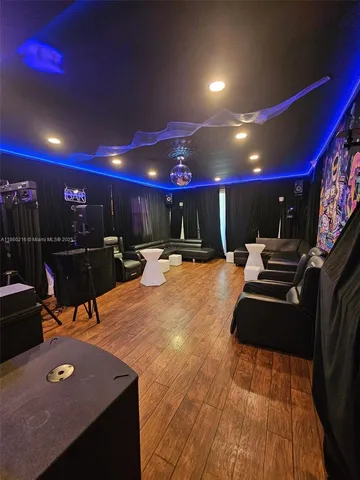 a large kitchen with stainless steel appliances granite countertop a stove a sink and a microwave