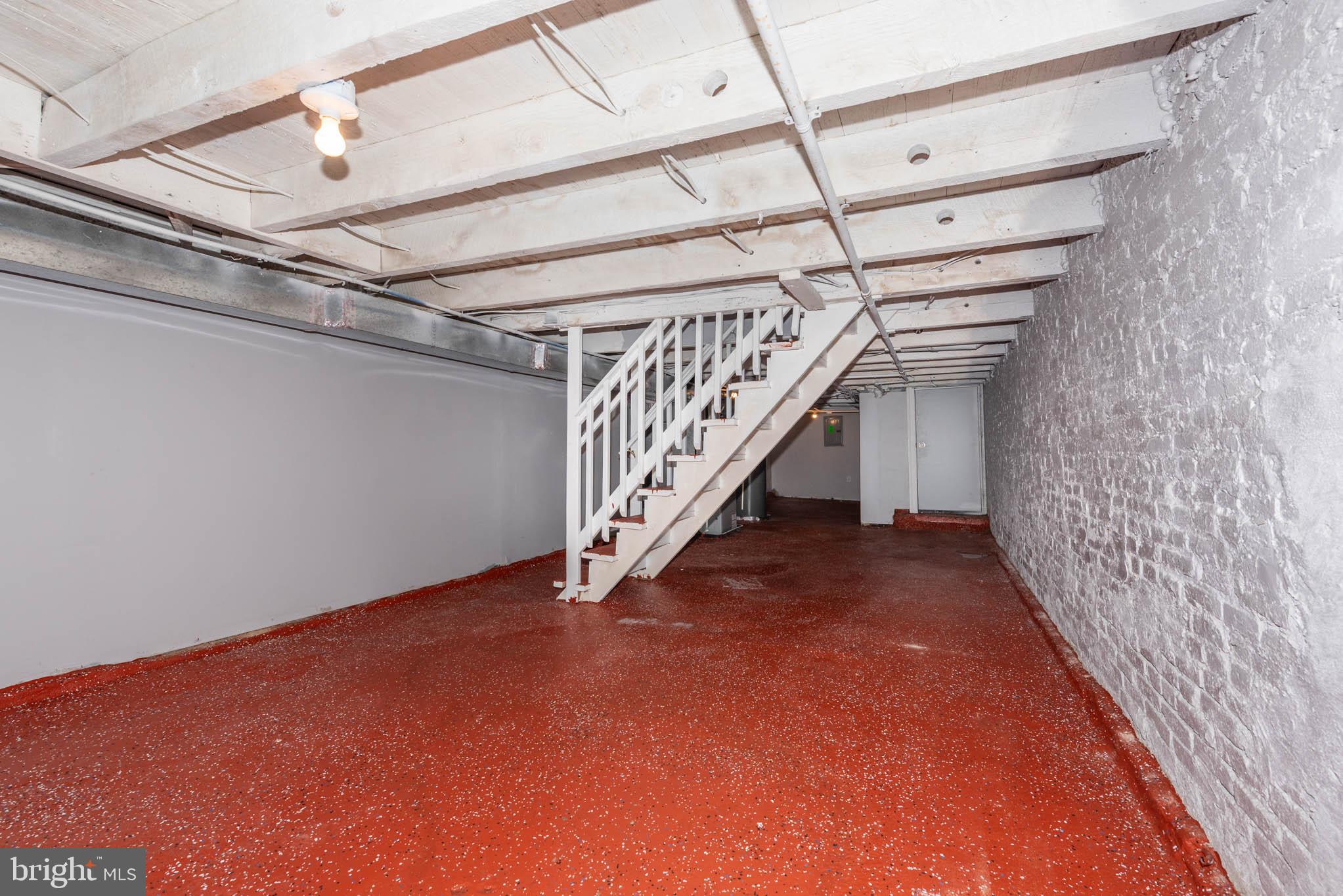 439 East 27th Street Baltimore, MD 21218 - Photo 22 of 30 a view of an empty room with stairs