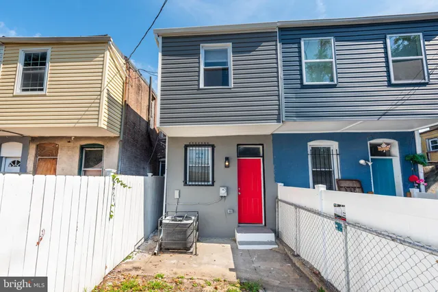 a front view of a house with wooden fence