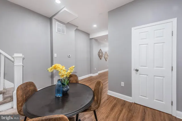 a dining room with furniture and wooden floor