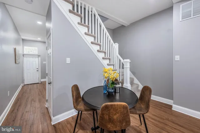 a dining room with furniture and wooden floor