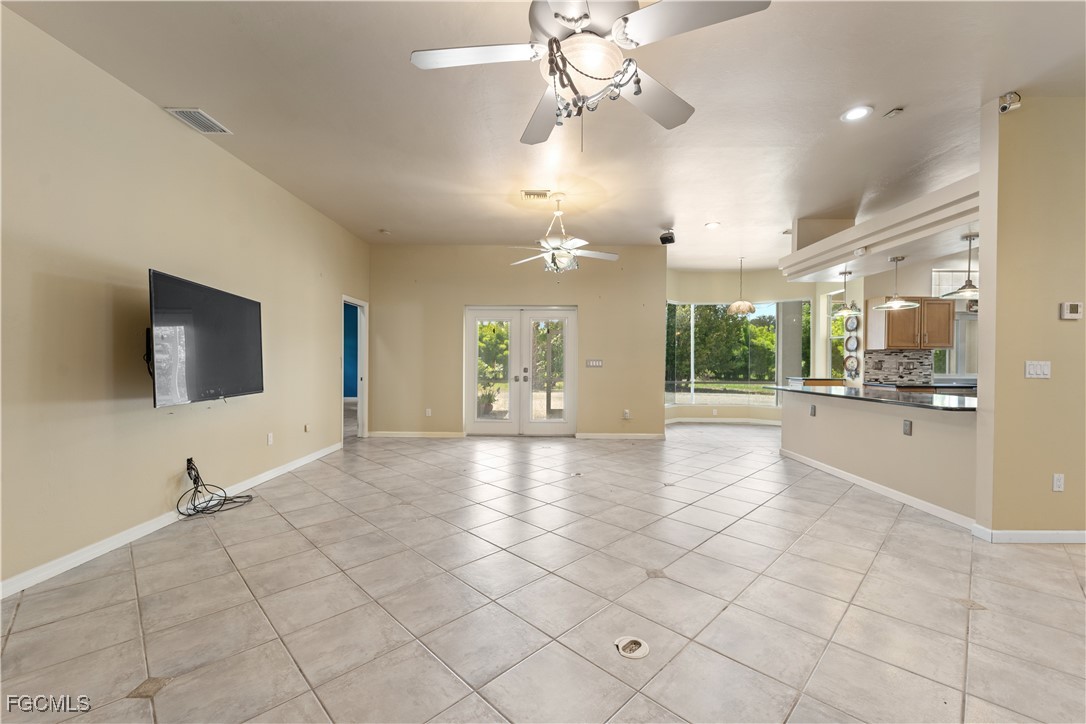 2050 Snyder Drive Alva, FL 33920 - Photo 14 of 49 a view of an empty room and kitchen view with wooden floor