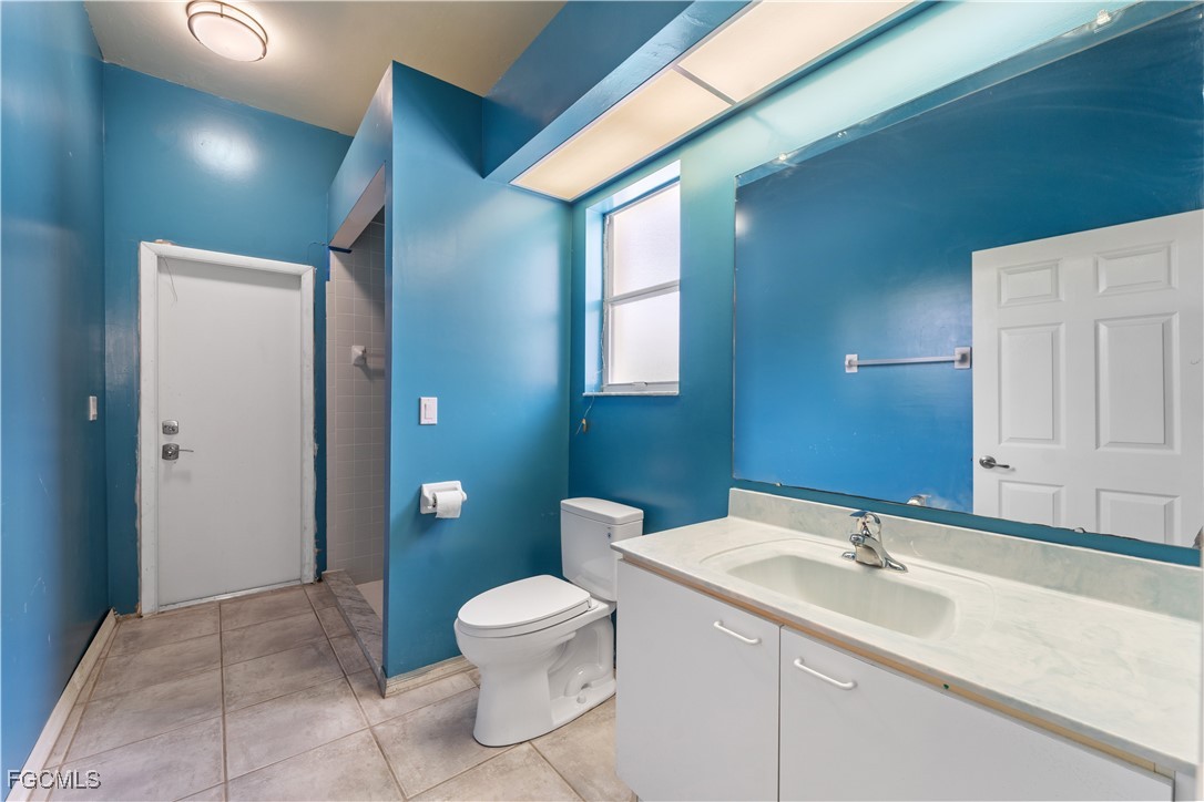 2050 Snyder Drive Alva, FL 33920 - Photo 44 of 49 a bathroom with a toilet sink and mirror