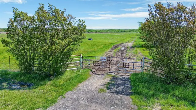 a view of a green field with an ocean view