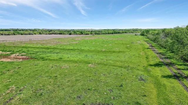 a view of a green field with an outdoor space