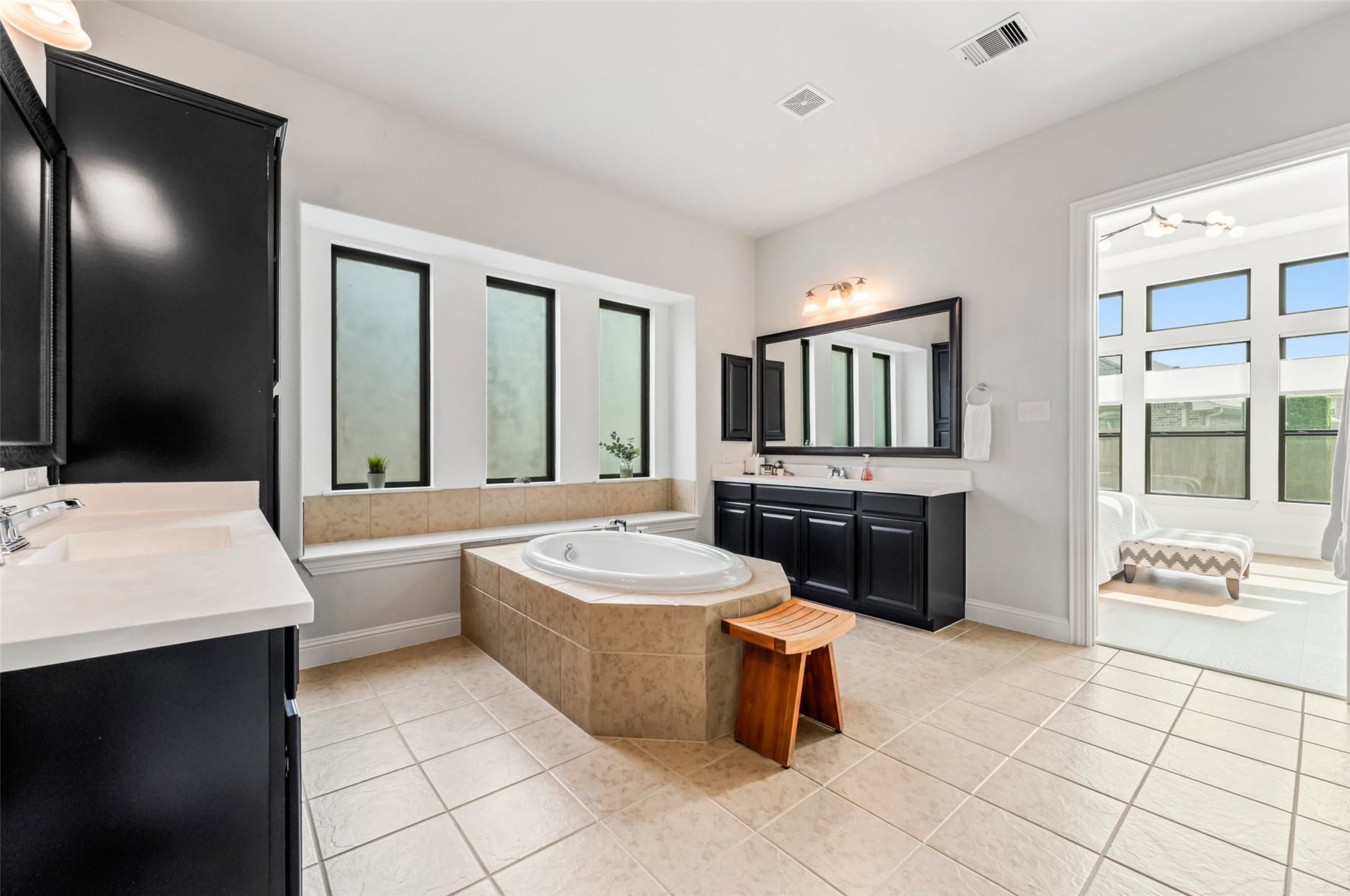 1053 Bat Hawk Court Conroe, TX 77385 - Photo 29 of 50 a large bathroom with a tub sink and mirror