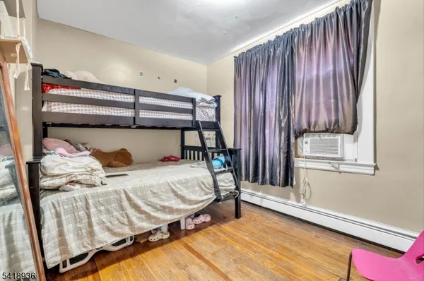 a bedroom with furniture and a wooden floor