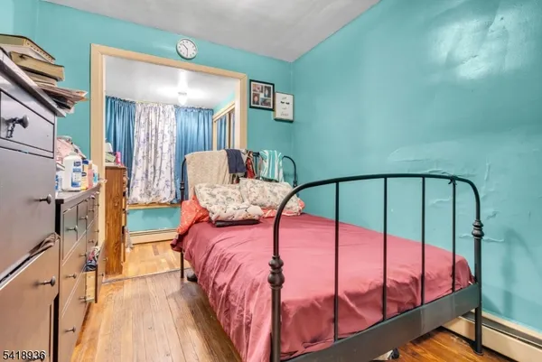 a bedroom with a bed and a mirror