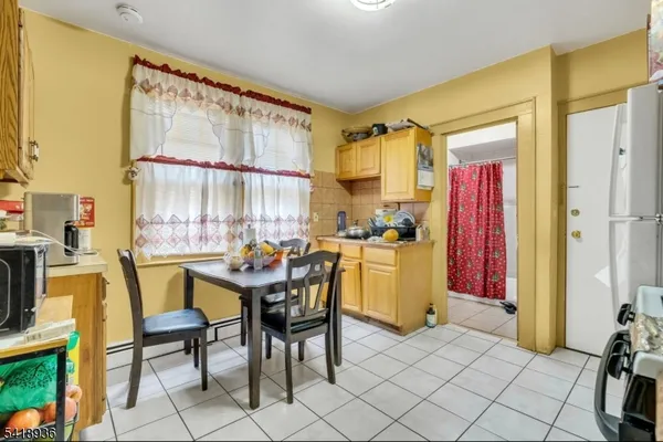 a view of a dining room with furniture and a chandelier