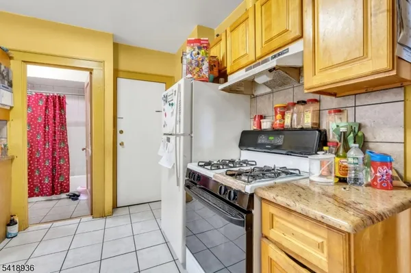 a kitchen with stainless steel appliances granite countertop a stove and a refrigerator