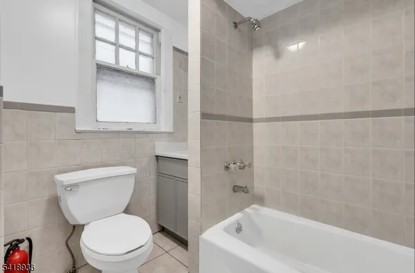 a white toilet sitting next to a bathroom sink and tub