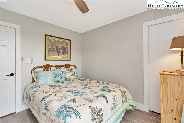 a bedroom with a bed and a painting on the wall