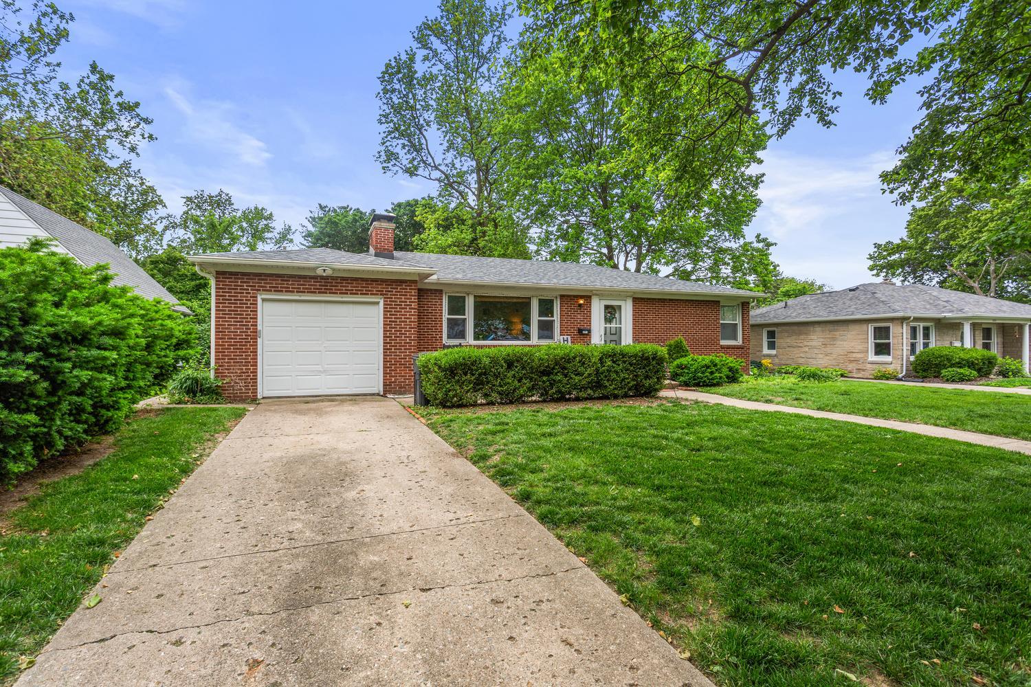 1117 West Union Street Champaign, IL 61821 - Photo 2 of 29 a front view of a house with a yard and trees