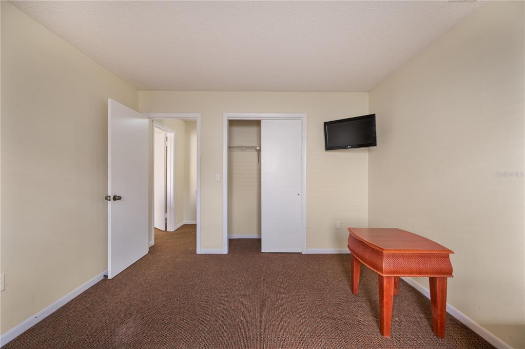 4231 Oak Loop, Unit 51 Mulberry, FL 33860 - Photo 22 of 29 a living room with a chair and a flat screen tv