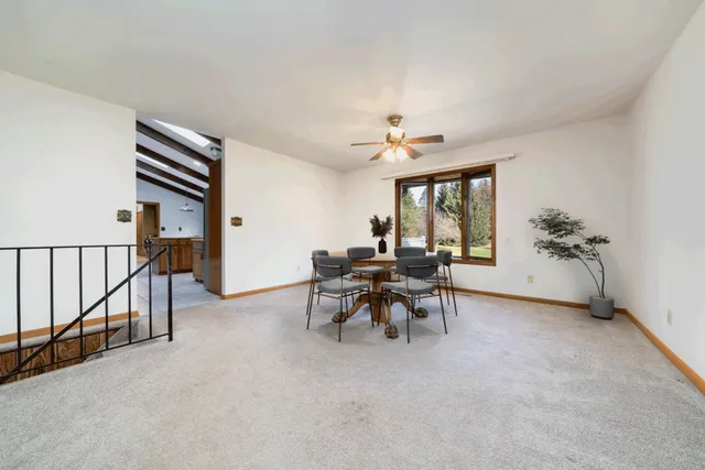 a view of a livingroom with furniture and a window