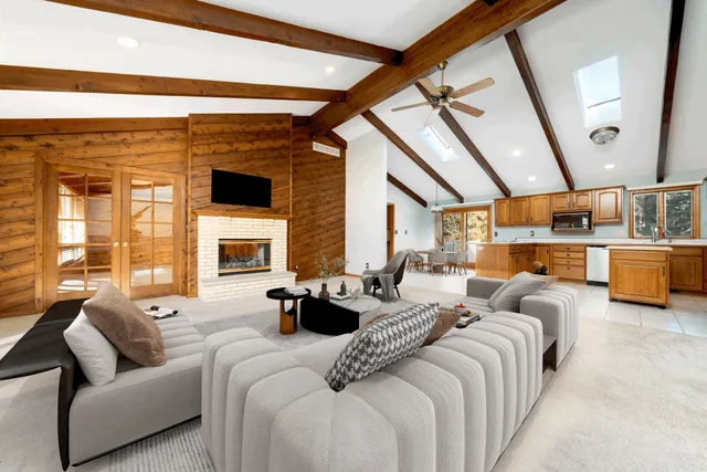 a large bedroom with furniture large window and fireplace