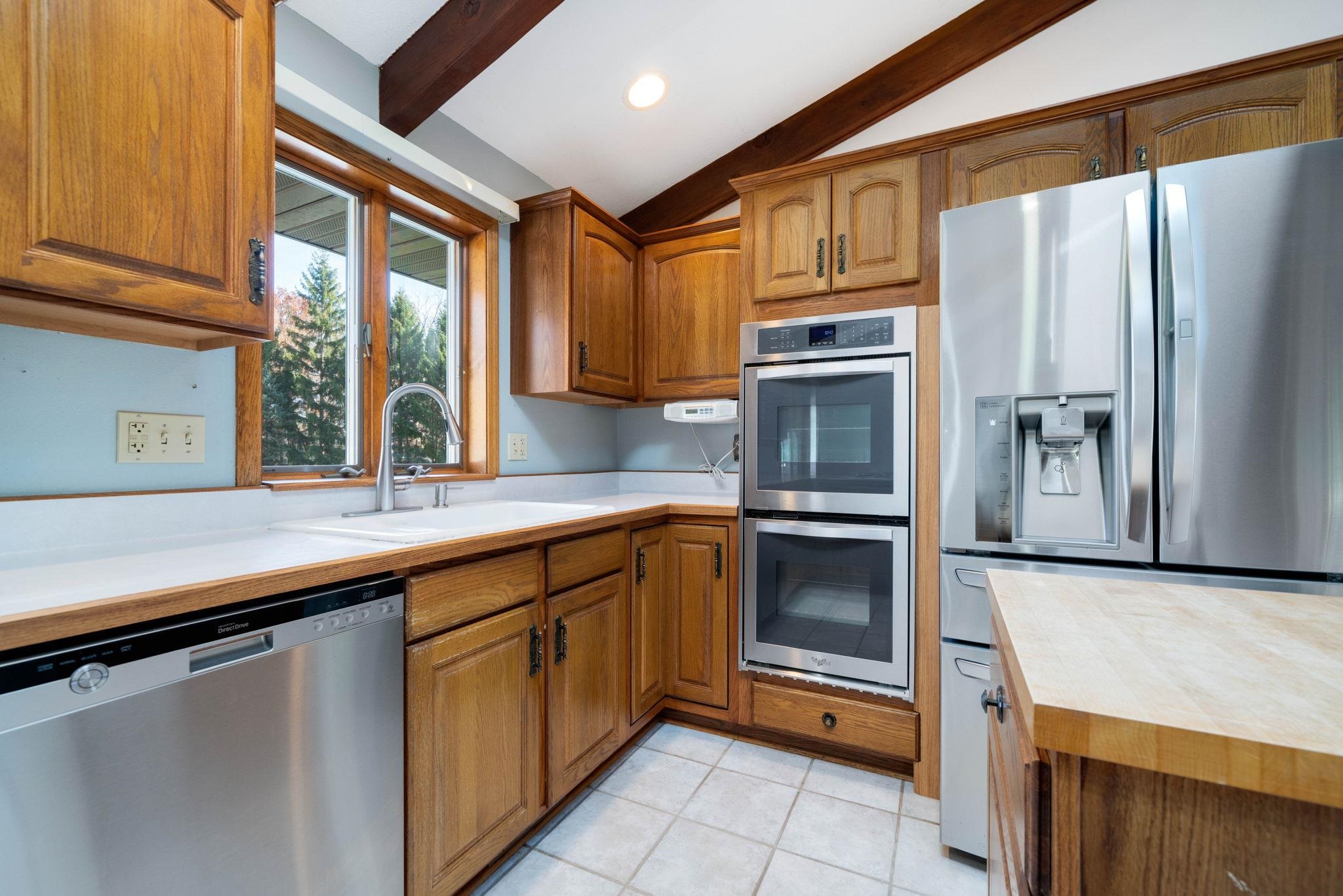 1198 Riverside Road Belvidere, IL 61008 - Photo 9 of 35 a kitchen with granite countertop stainless steel appliances and wooden cabinets
