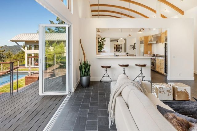 a view of a bedroom with a bed and wooden floor