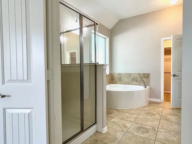 a bathroom with a bathtub and a shower