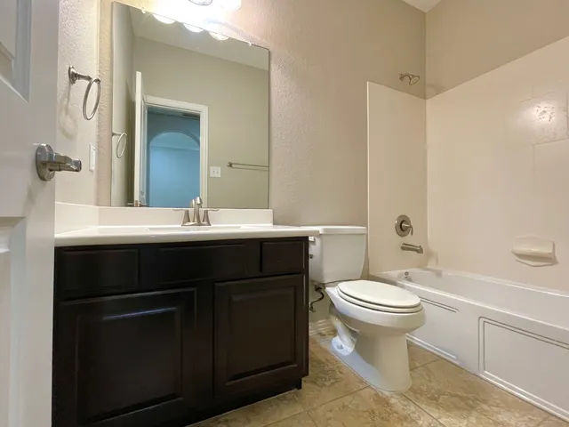 a bathroom with a sink toilet and a mirror