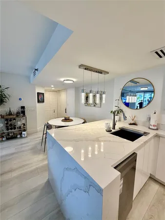 a kitchen with stainless steel appliances a sink and a stove