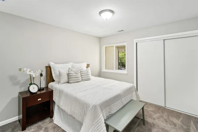 a bedroom with a bed and a window