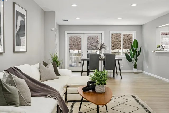 a living room with furniture potted plant and windows