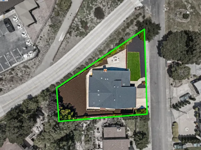 an aerial view of a house with a yard and a fountain