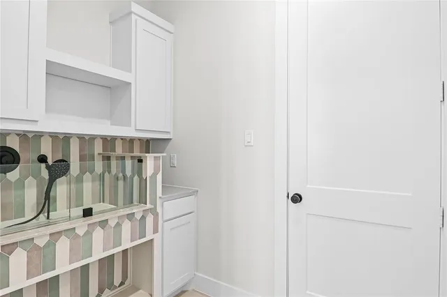 a view of staircase with white walls and railing