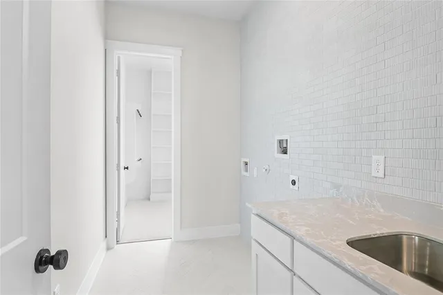 a bathroom with a granite countertop sink a mirror and shower