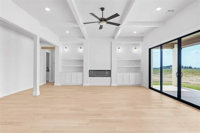 a view of an empty room with a kitchen