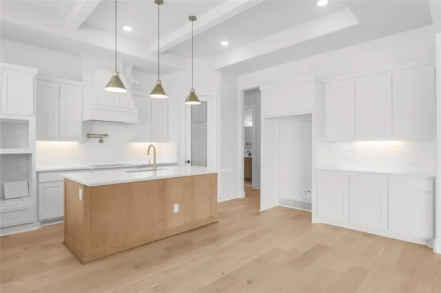 a kitchen with stainless steel appliances granite countertop a sink a stove and a refrigerator