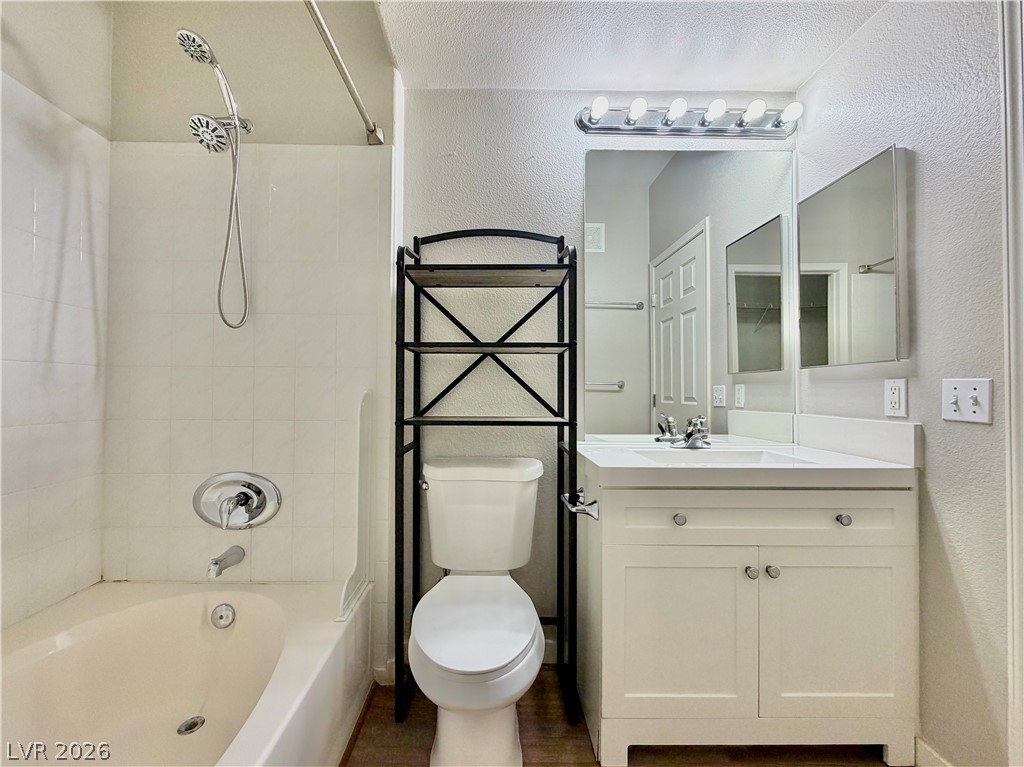 8555 West Russell Road, Unit 2018 Las Vegas, NV 89113 - Photo 16 of 23 Modern bath features a single vanity, clean white surfaces, and a combination tub-shower.