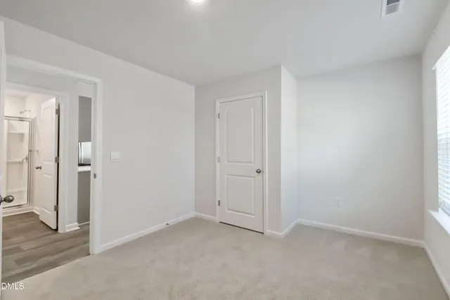 a view of an empty room and wooden floor