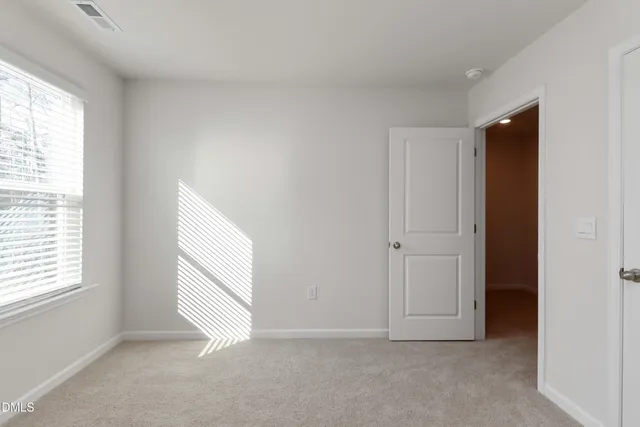 a view of an empty room and a window