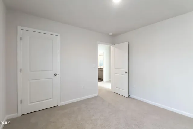 a view of an empty room and closet area