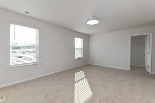 a bathroom with a toilet a sink and wooden floor