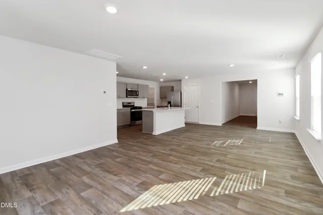 a view of a kitchen with a sink and a refrigerator