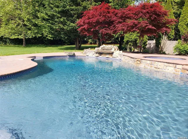 a view of swimming pool with a yard