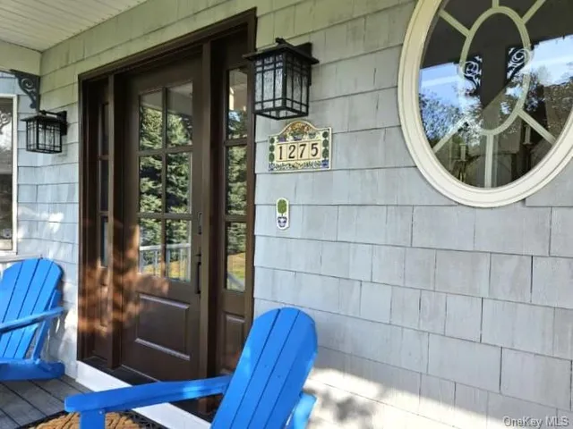 a living room with furniture a large window with wooden floor