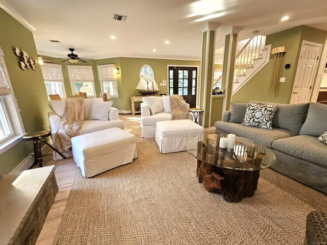 a kitchen with a stove a refrigerator and a dining table with wooden floor