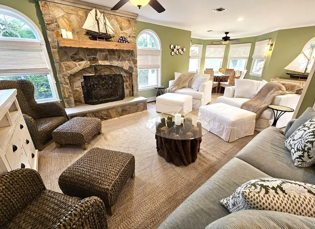 a living room with furniture a large window with wooden floor