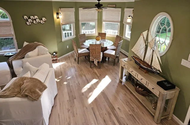 a living room with furniture and large windows